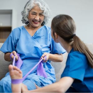 Elderly Woman Performing Physical Therapy Exercises with Nurse in Assisted Living Facility