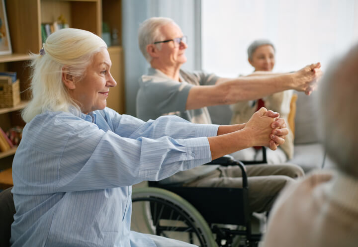 Elderly Residents Stretching During Group Exercise at Assisted Living Facility Elderly Residents Stretching During Group Exercise at Assisted Living Facility