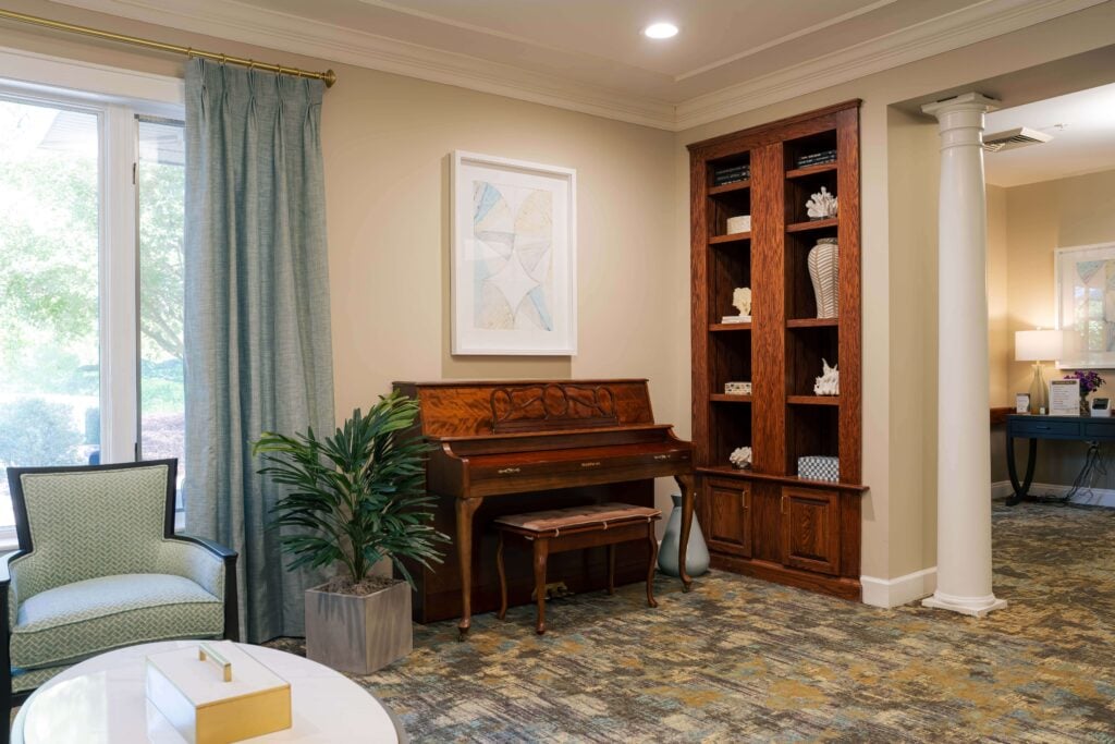 Piano Beside Built-in Oak Bookcase at Assisted Living Facility