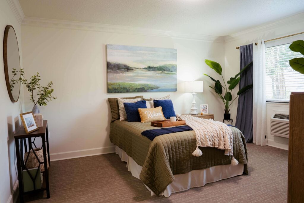 Cozy Bedroom With Landscape Artwork at Assisted Living Facility