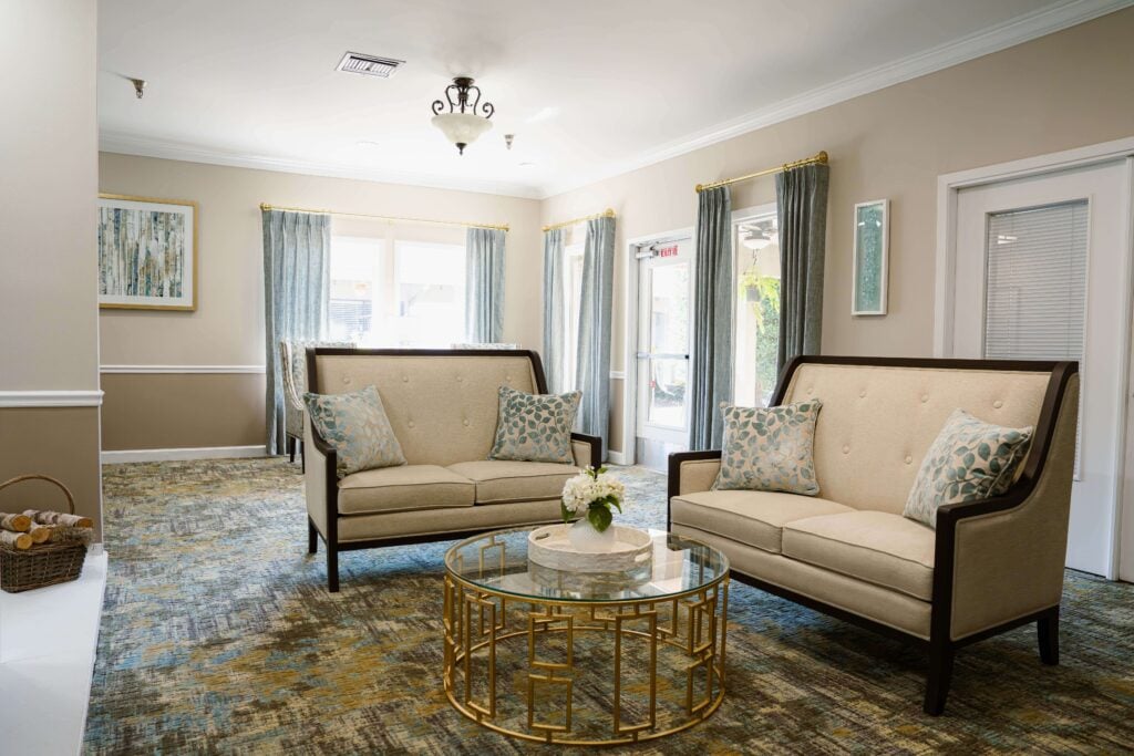 Matching Settees Around Glass Coffee Table at Assisted Living Facility