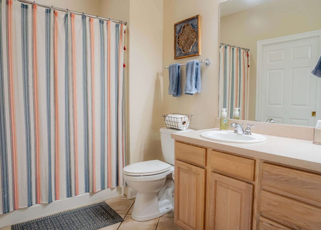 Clean Bathroom With Vanity and Shower in Independent Living Cottages